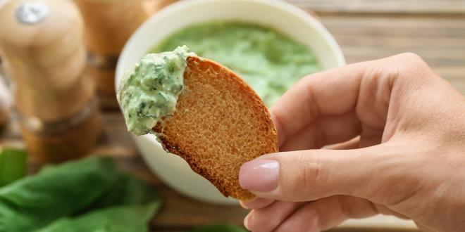 toasted bread dipped into spinach-cheese dip