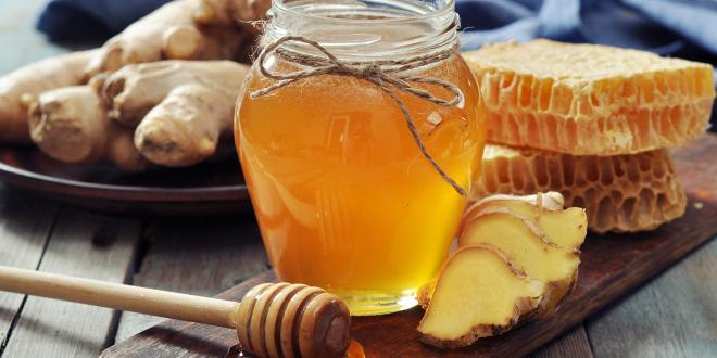 a jar of honey and fresh sliced ginger root